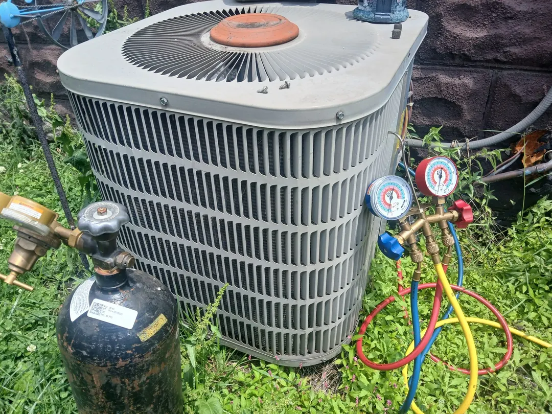 HVAC technician servicing a rooftop unit in Northwest Indiana