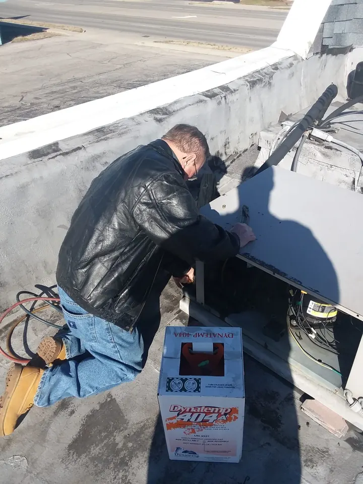 Technician servicing HVAC equipment — Lee's Heating & Cooling